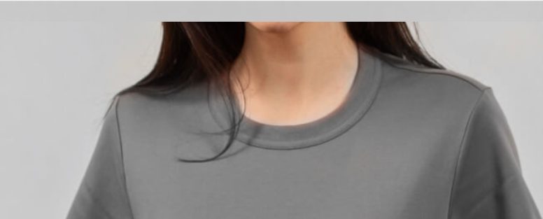 Woman wearing a heather grey crew-neck tee